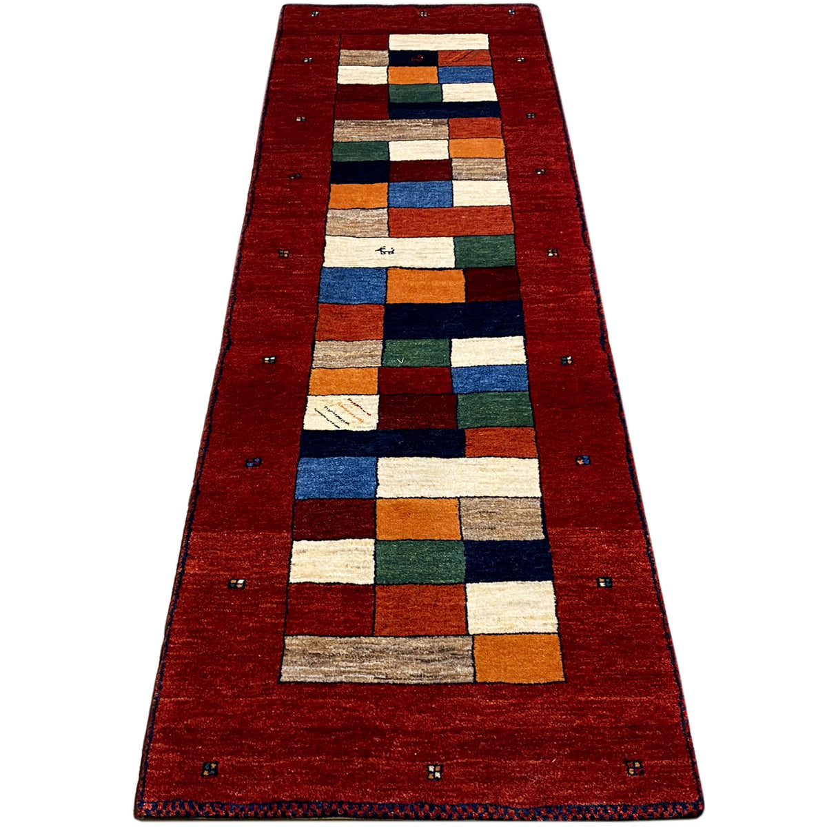 Gabbeh runner rug with a red background and multicolored squares in the central area