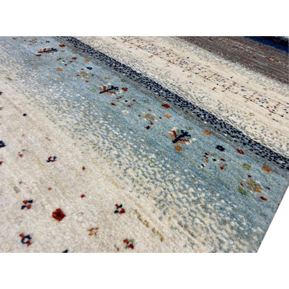 Gabbeh rug runner detail: Light beige surface with blue stripes and small patterns