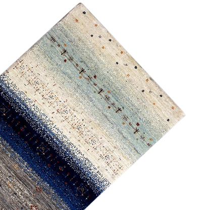 Gabbeh runner rug detail at the corner: light beige with light blue and a darker stripe