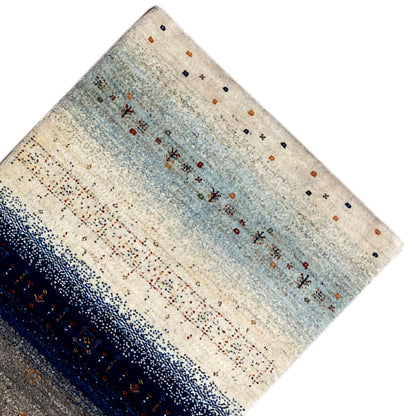 Gabbeh rug runner corner: light blue stripe, dark border, and fine pattern dots