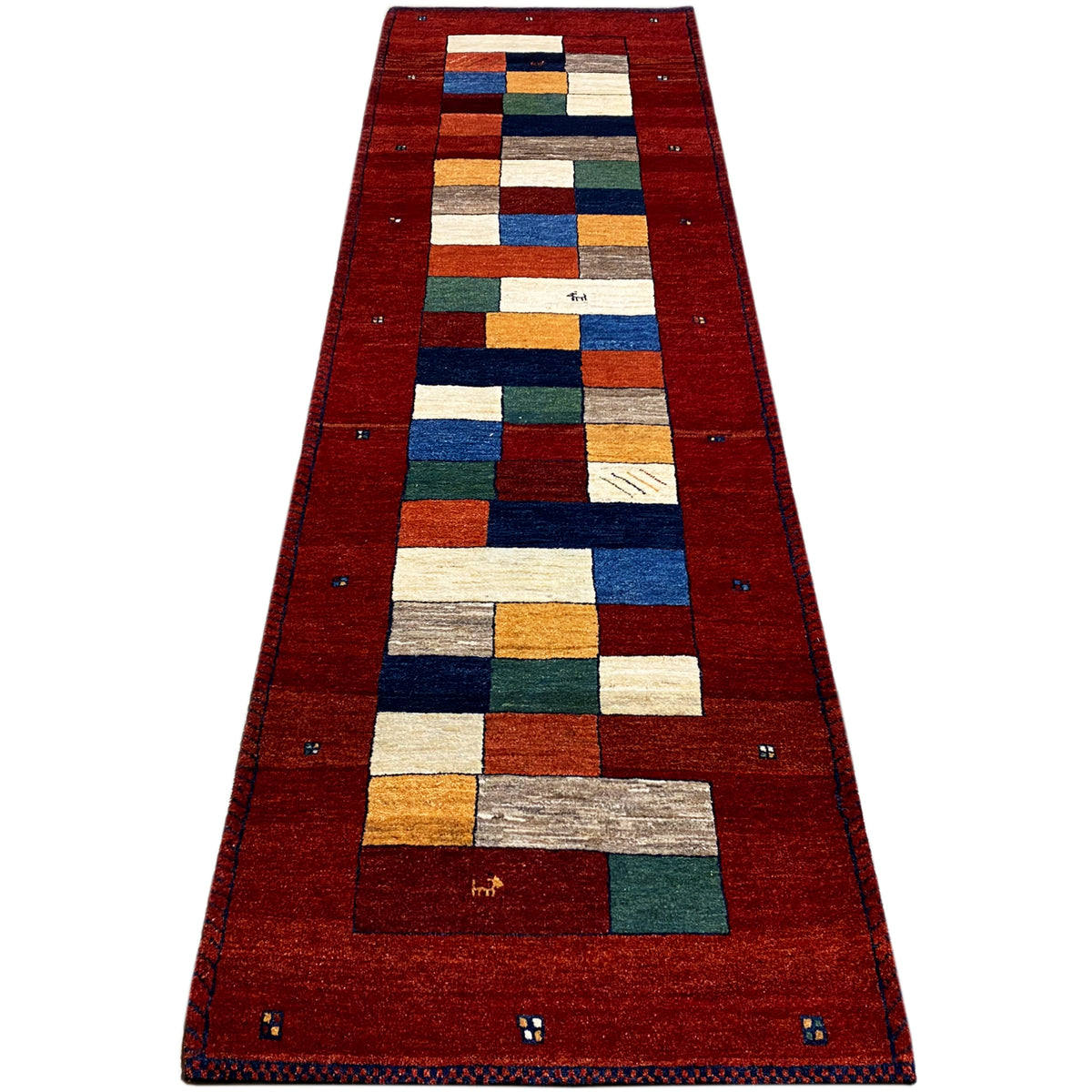 Red carpet runner with a long border and geometric patchwork pattern in colors