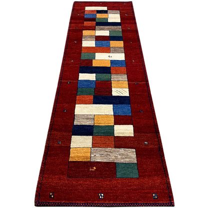 Red carpet runner with a long border and geometric patchwork pattern in colors