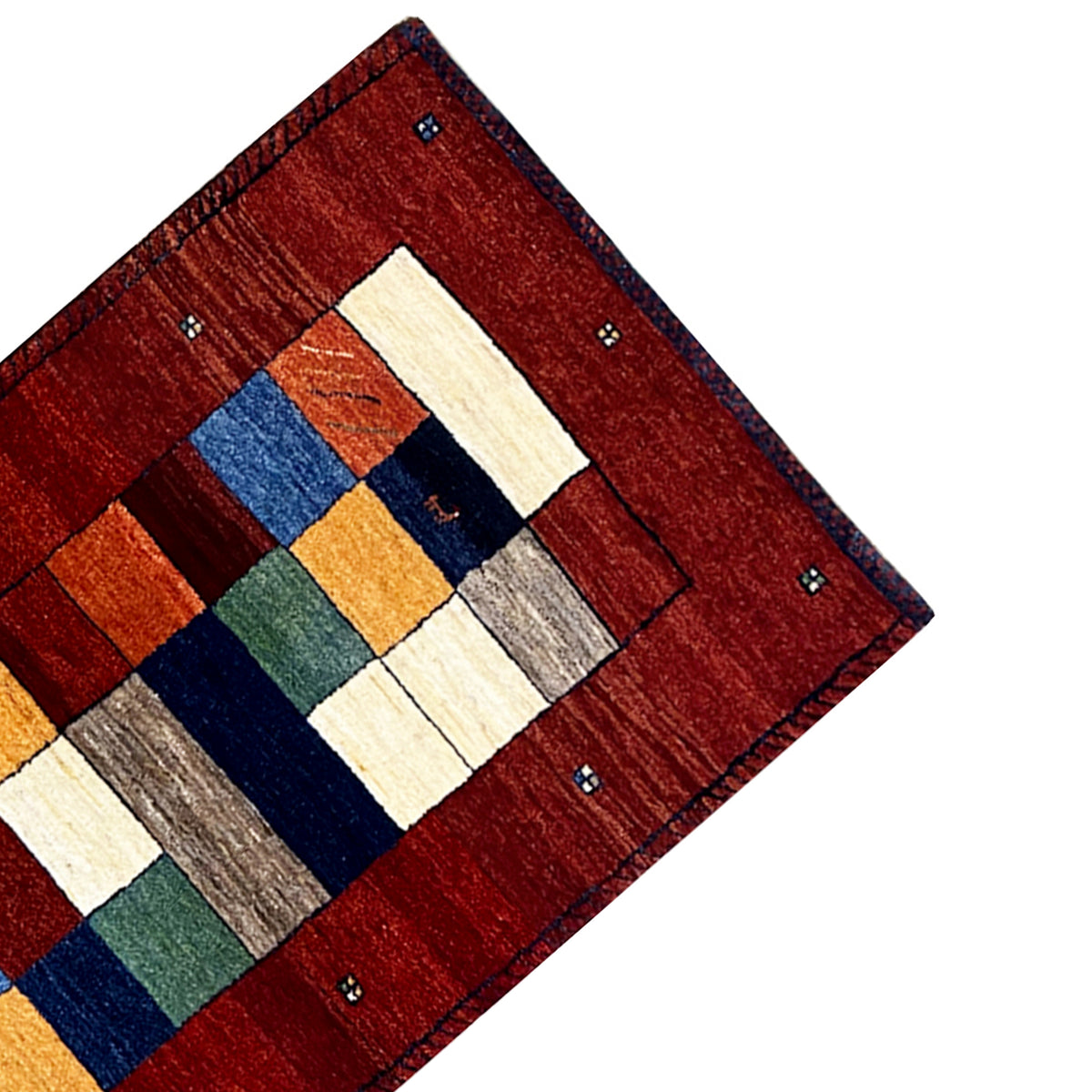 Close-up of a corner: red runner rug with geometric squares in contrasting colors