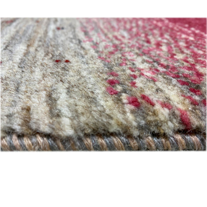 Close-up of a Gabbeh rug: beige field with red accents and a short pile