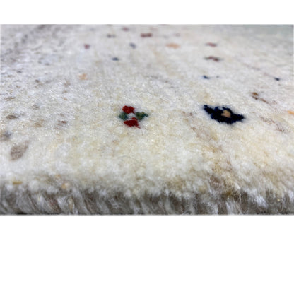 Close-up of the pile: light Gabbeh rug with a small blue and red pattern