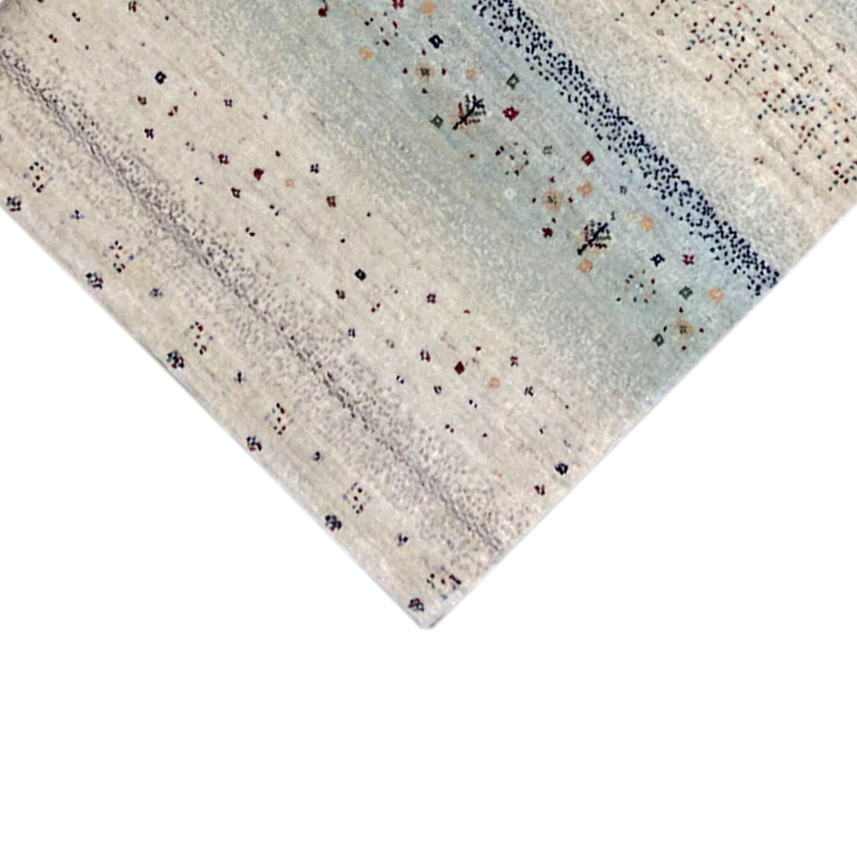 Gabbeh rug runner corner with a light blue background, colorful dots, and floral patterns