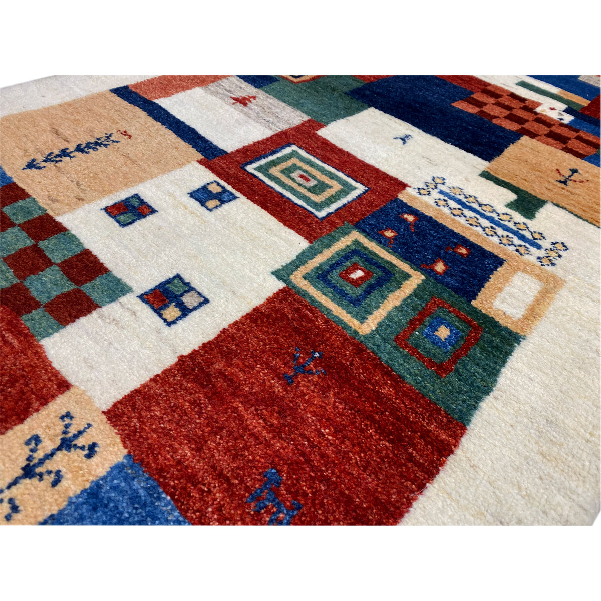 Close-up: Gabbeh rug pattern with diamonds, stripes, and small symbols in colors