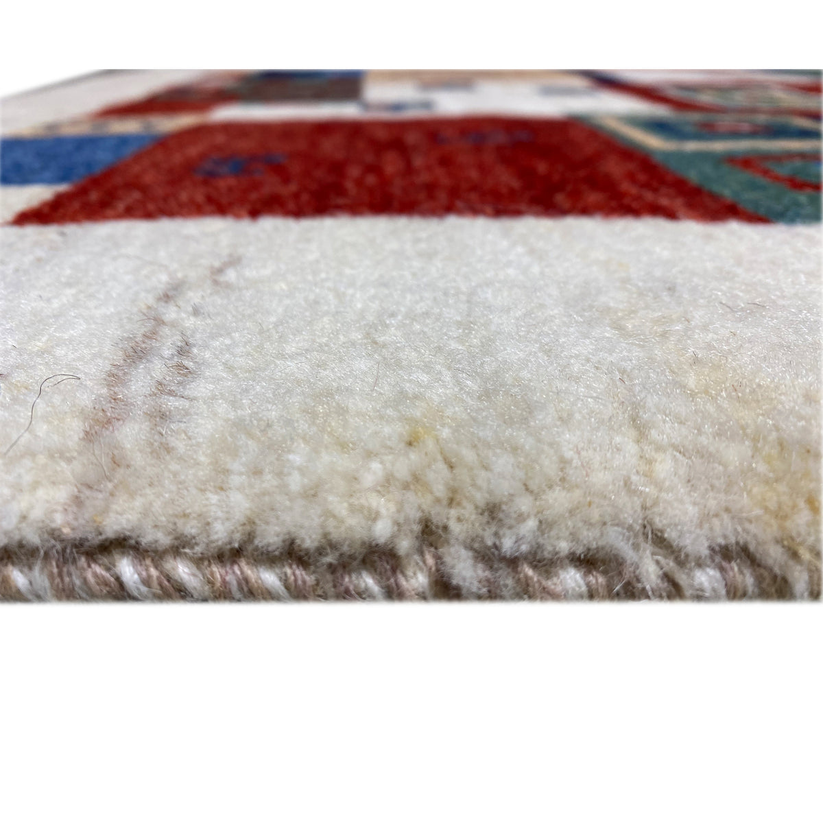 Gabbeh rug, detail of the pile surface with multicolored elements and border