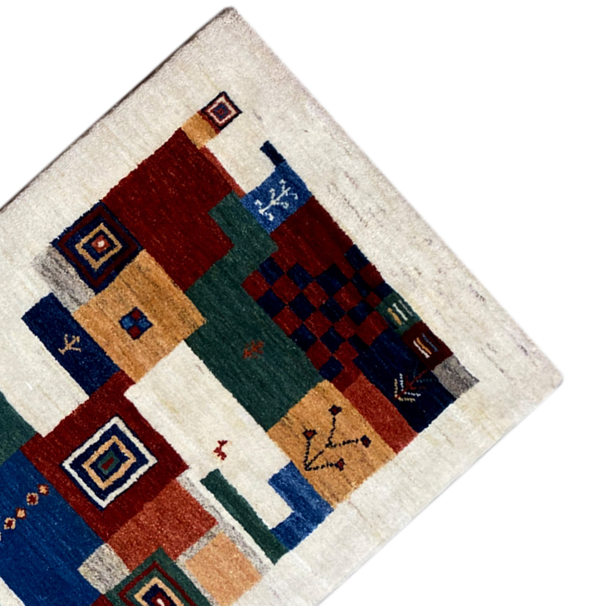 Gabbeh rug corner with colorful squares, diamonds, and a dark patterned area