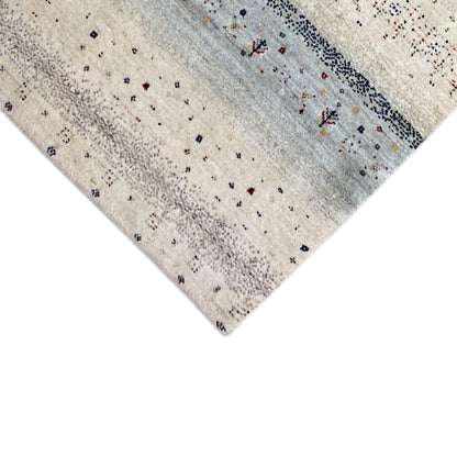 Close-up edge: Gabbeh runner rug with light beige pile and a blue-gray stripe