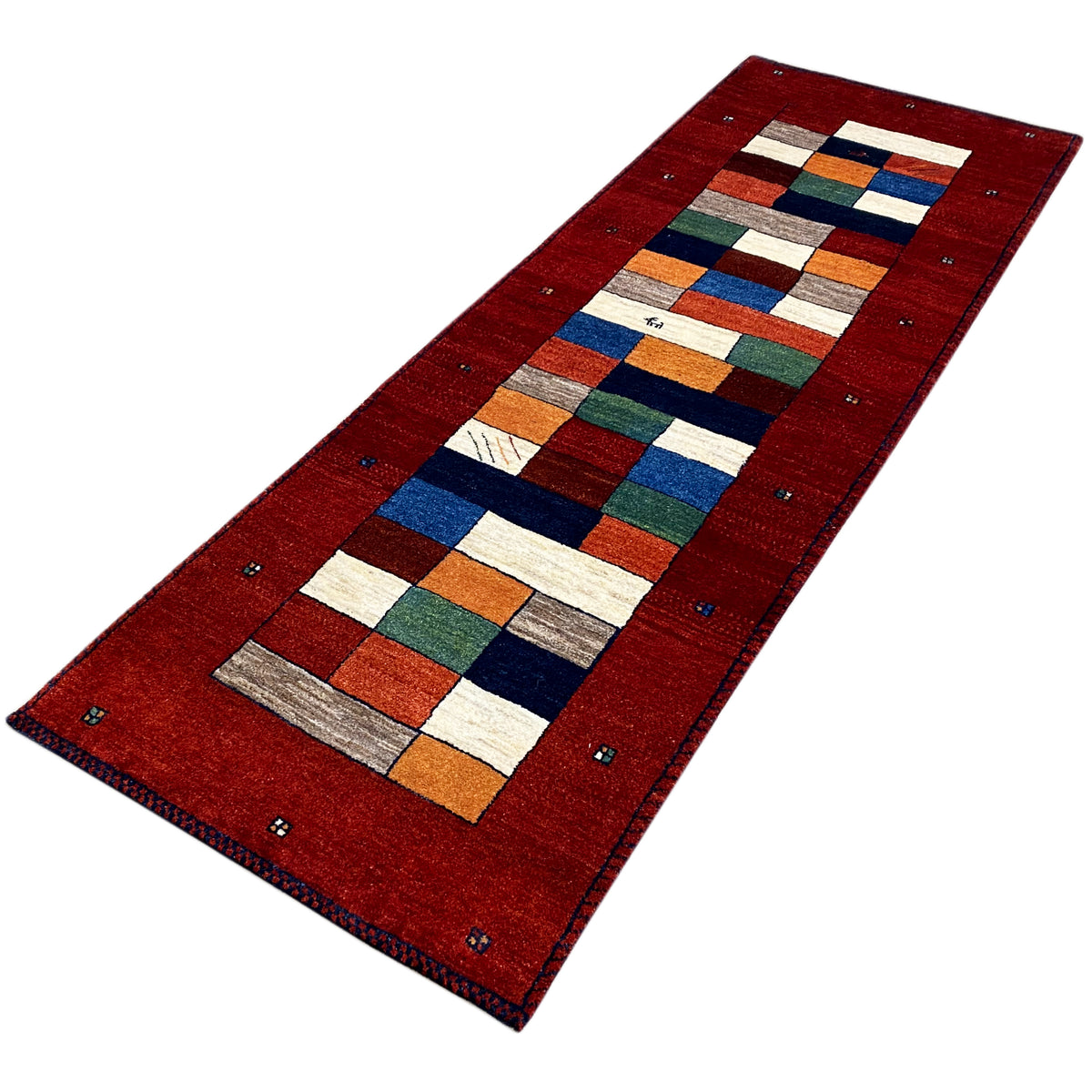 Red runner rug with central patchwork and multicolored block rows, finely bordered