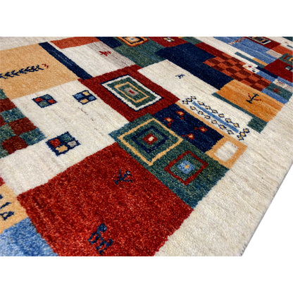Close-up of Gabbeh rug: red surface, blue and green squares in a patchwork pattern
