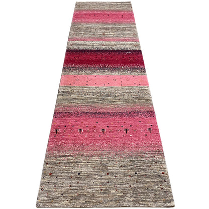 Gabbeh runner rug with lengthwise stripes in pink, gray, and dark red.