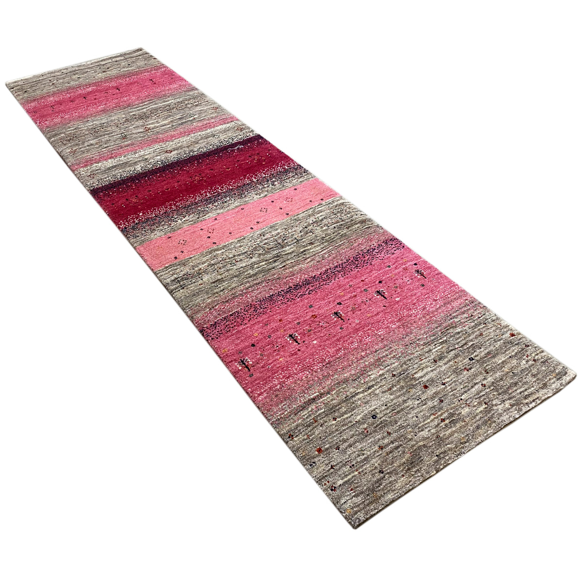 Gabbeh runner rug spread diagonally, with stripes in pink, gray, and dark red.