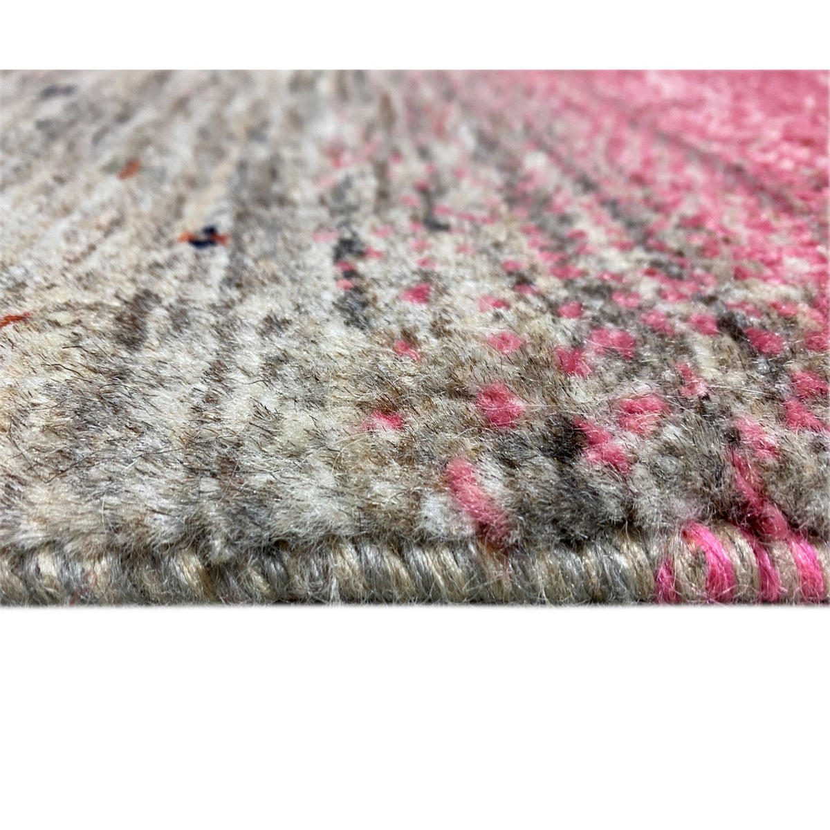 Gabbeh rug runner detail view: gray pile with pink accents and fine patterned dots.