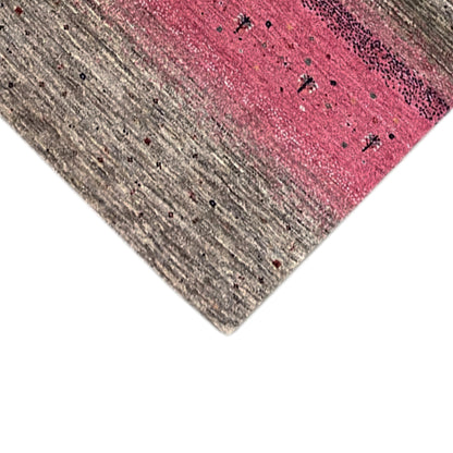 Gabbeh rug runner edge view with textured gray and pink stripes.