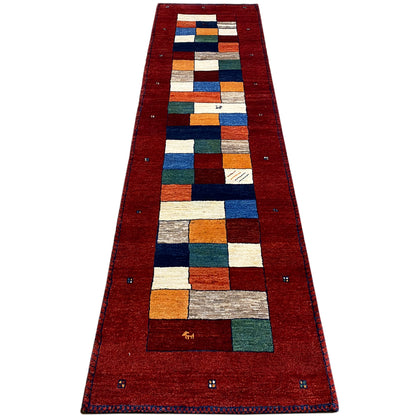 Red runner with a long geometric central motif made of colored cubes