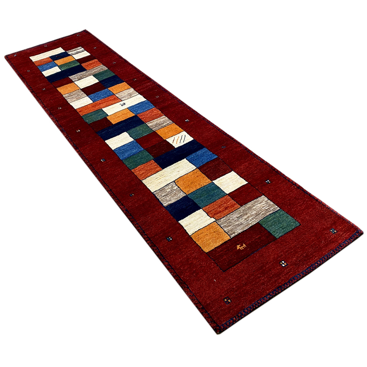Red carpet runner at an angle with a square block pattern in blue, green, and orange