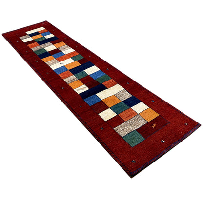 Gabbeh runner rug in a diagonal pattern: red background with multicolored rows of blocks