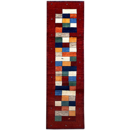 Gabbeh rug runner with a red background and a geometric square pattern in blue, green, and beige