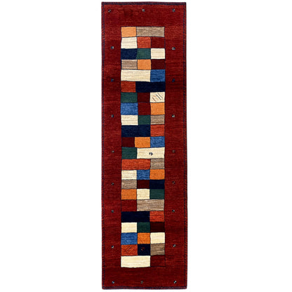 Red Gabbeh runner rug with a patchwork square pattern and blue border