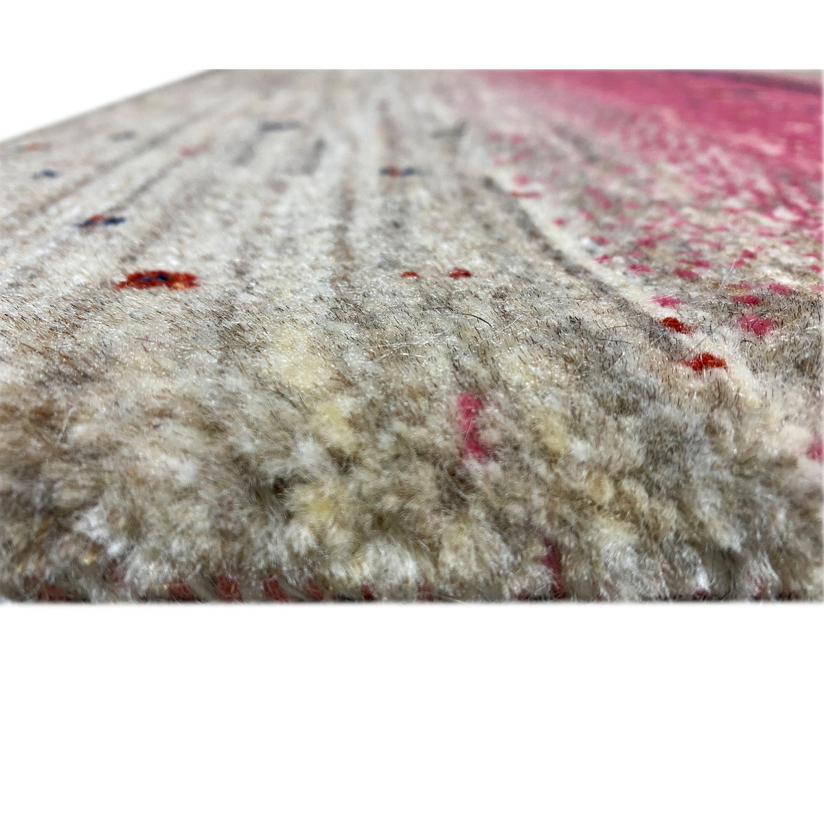 Gabbeh rug runner detail: beige pile texture with pink stripes and colorful dots