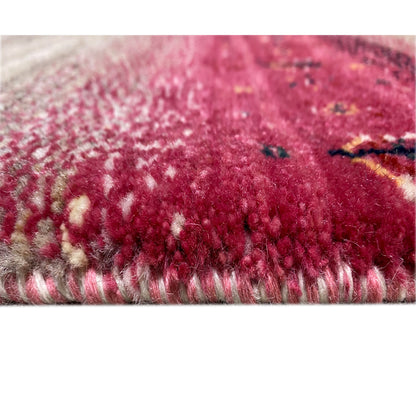 Close-up of a Gabbeh rug runner with a pink and beige pile along the edge
