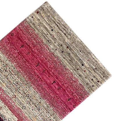 Gabbeh rug runner detail: striped pattern in beige, red, and dark dots