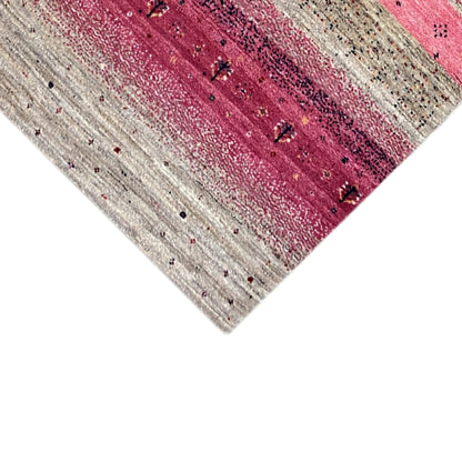 Gabbeh rug runner corner detail with beige and pink stripes, fine dots