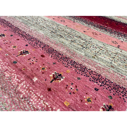 Close-up of a Gabbeh runner: pink stripes with a sequin effect and dark embroidered dots