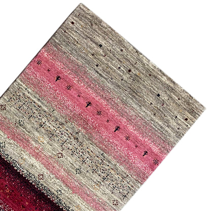Gabbeh runner in angled view: beige background with a pink central band and border