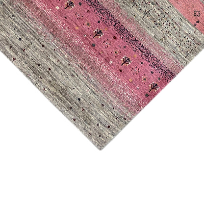 Close-up: pink center band with a sparkling effect, beige striped background and dots