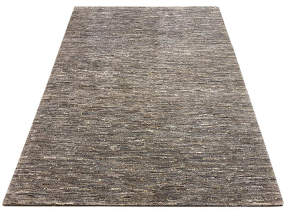 Rug in mottled dark and light gray, with fine gold-colored speckles.
