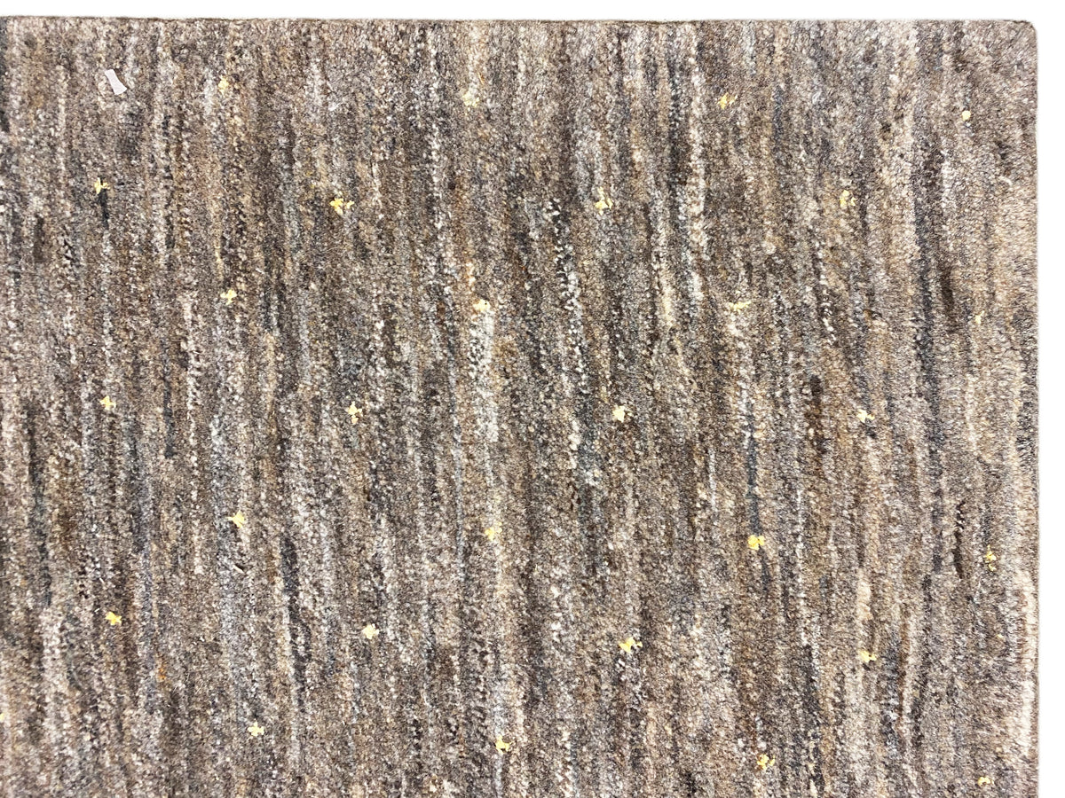 Close-up of the carpet surface: vertical pile stripes with golden accents.