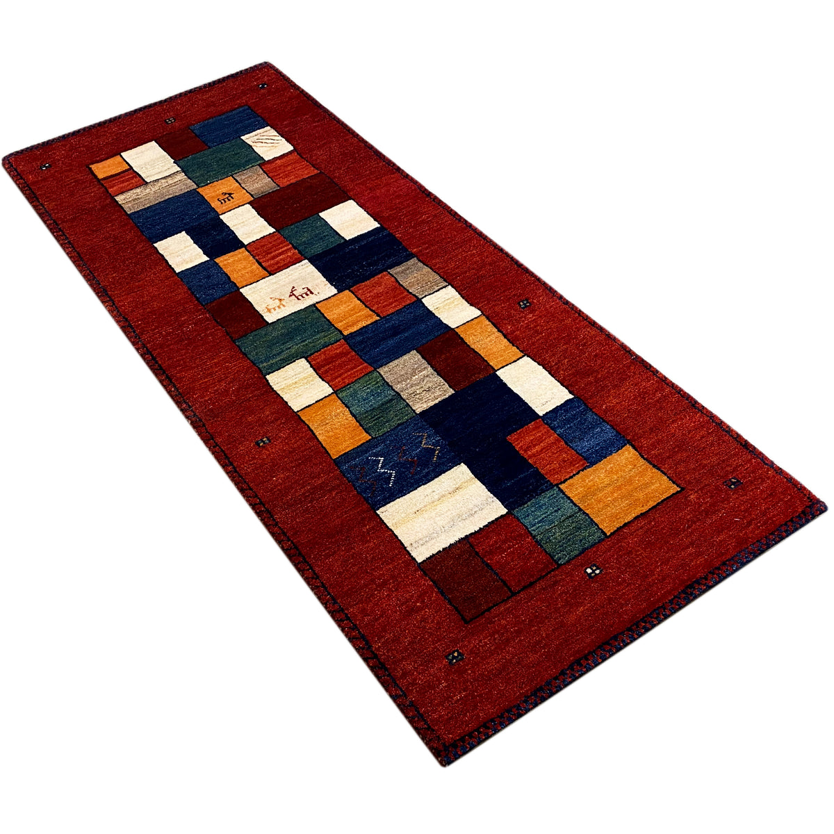 Gabbeh runner rug in a diagonal view: red border with blue and white color squares