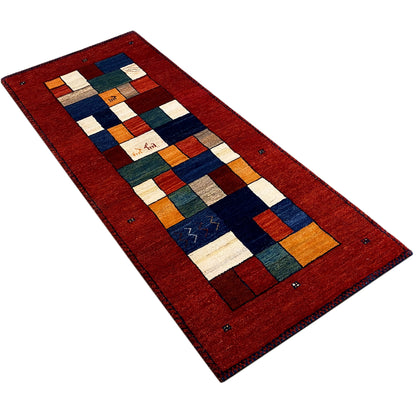 Gabbeh runner rug in a diagonal view: red border with blue and white color squares