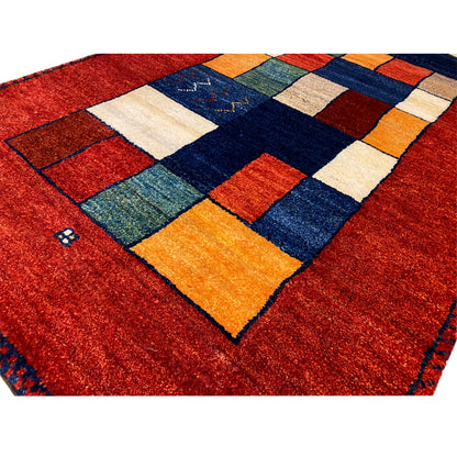 Gabbeh rug runner detail view: red pile fabric with colorful squares