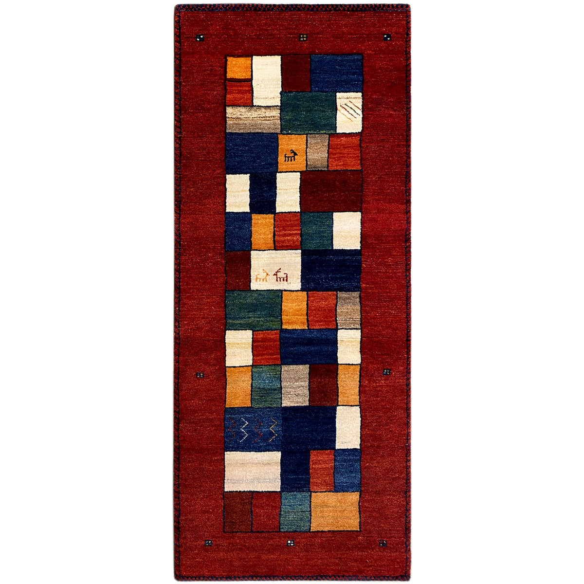Gabbeh rug runner with a red background and geometric patchwork in blue, green, and beige