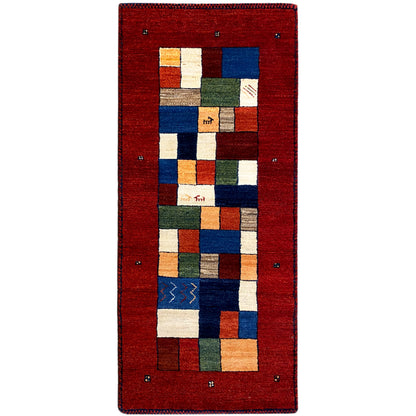 Red Gabbeh runner rug with a geometric patchwork pattern in blue, green, and beige.