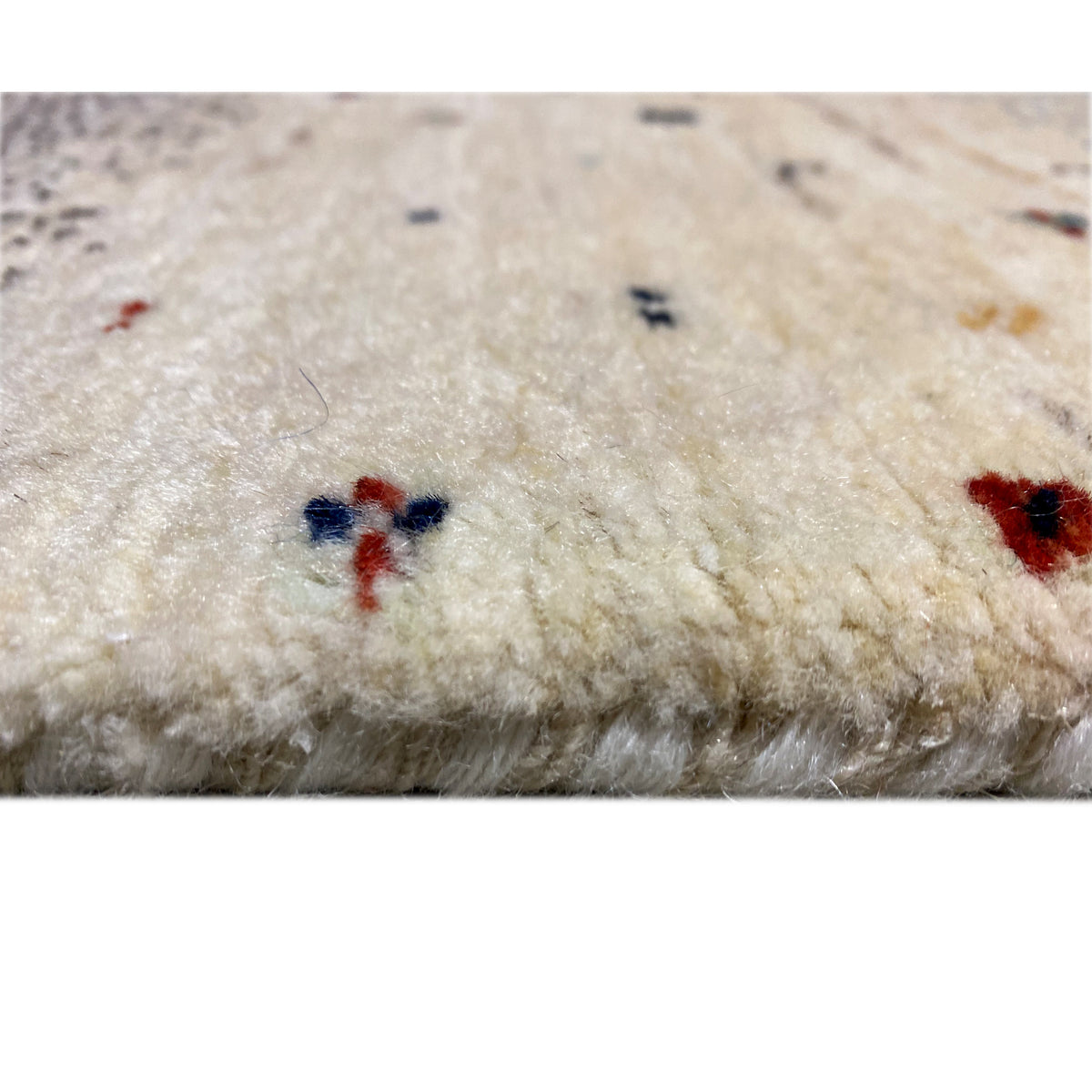 Gabbeh runner rug detail: soft pile surface with small multicolored accents