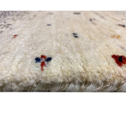 Gabbeh runner rug detail: soft pile surface with small multicolored accents