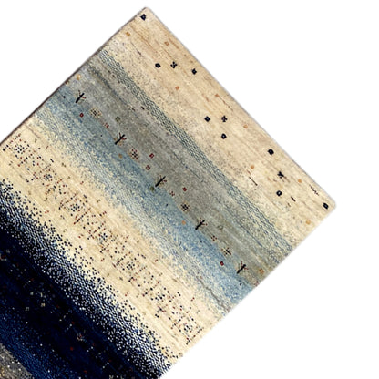 Gabbeh rug runner corner with a blue-beige striped gradient and dark dots