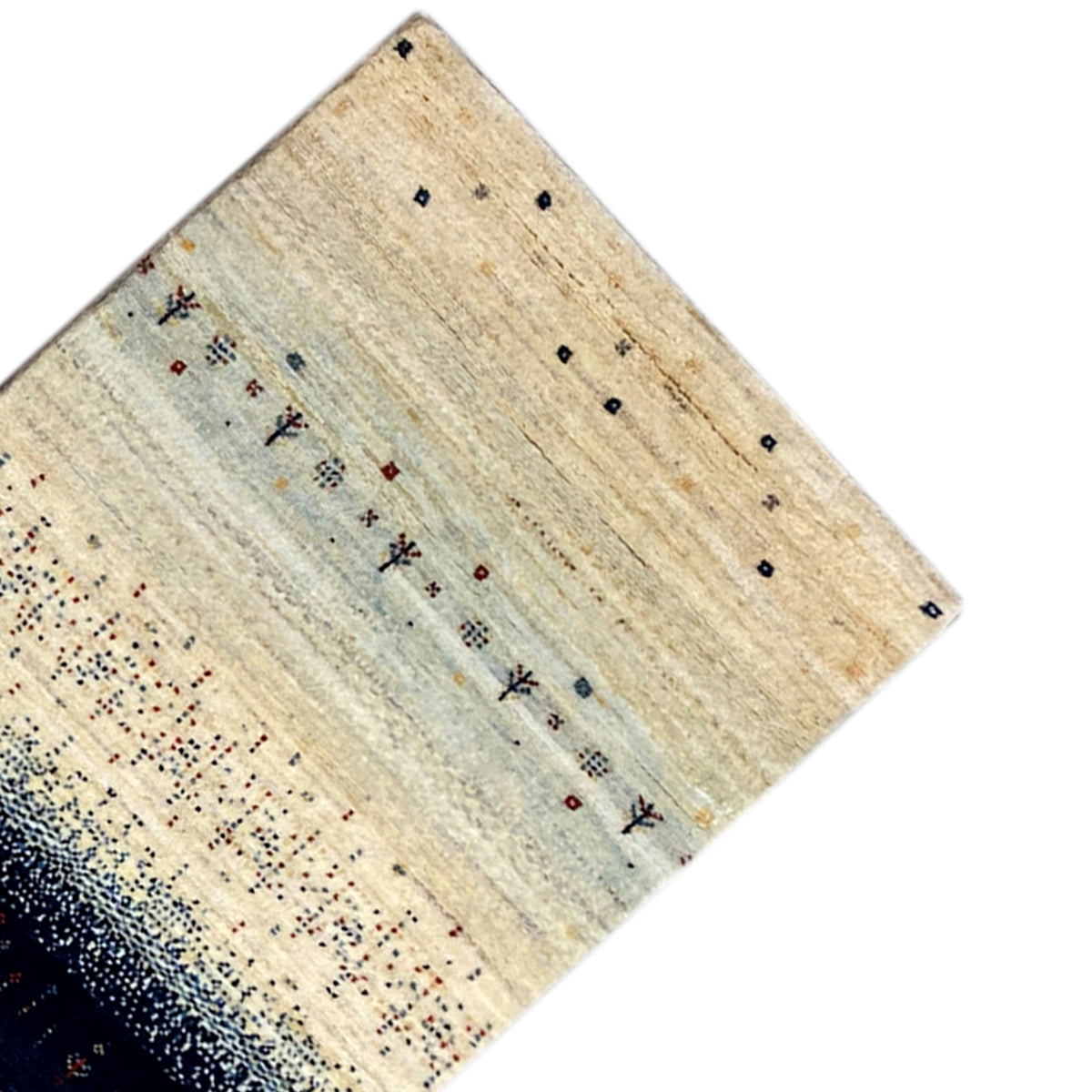 Corner of a Gabbeh runner rug: beige field with fine dots, dark blue stripe at the bottom