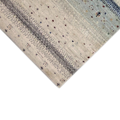 Gabbeh runner rug detail at the edge, light-colored area with gray stripes and small dots