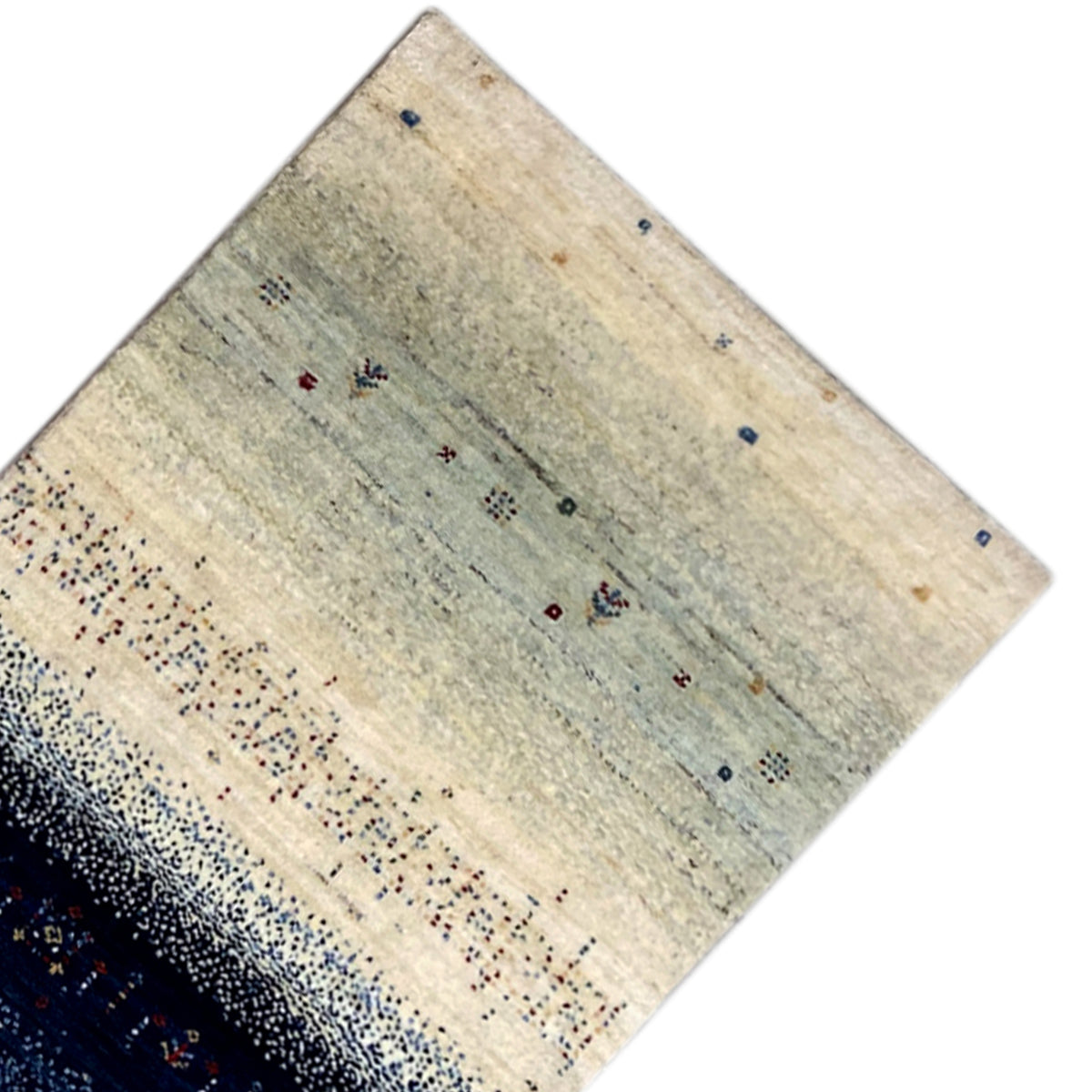 Gabbeh rug runner corner with a light beige background and scattered blue and red dots