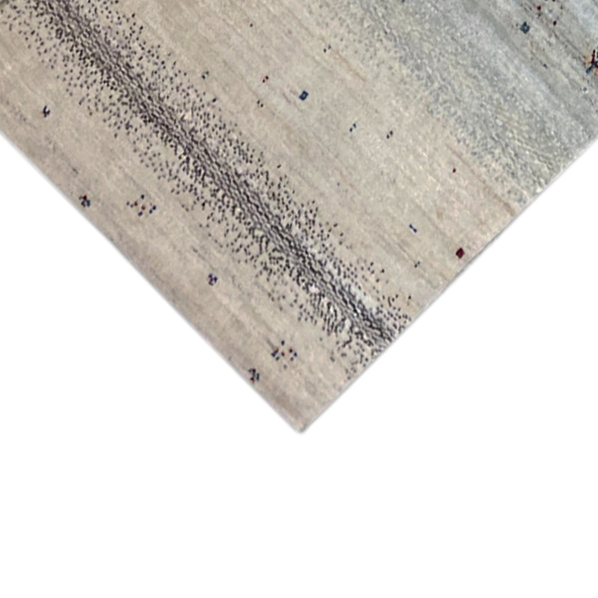 Carpet corner with a beige base, fine dotted pattern, and blue accents