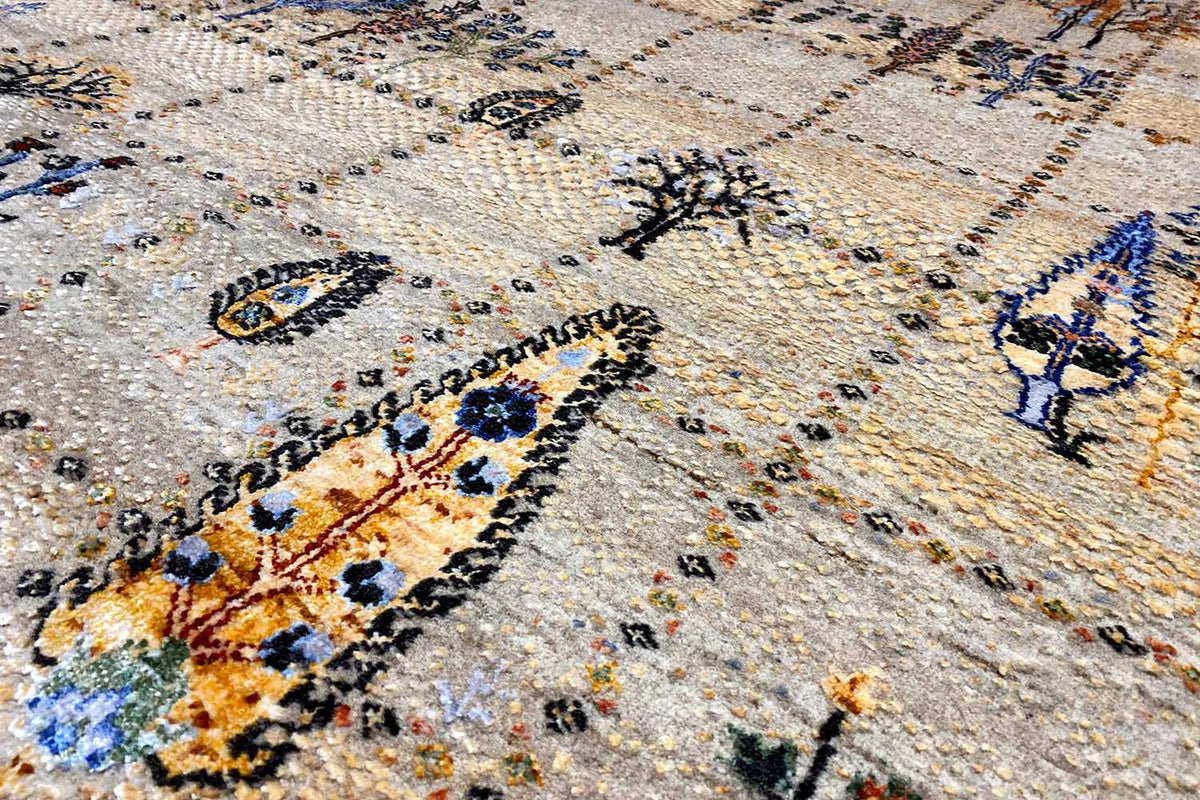Detailed view: beige carpet fabric with blue and golden-orange ornamental stitching