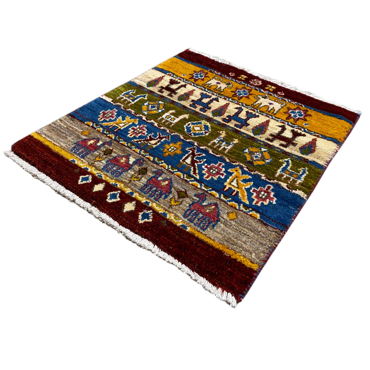Gabbeh rug Lori 65×56 cm, photographed at an angle, borders and braided patterns in blue/red