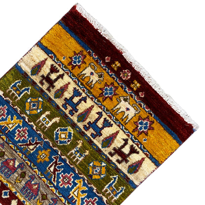 Gabbeh rug Lori 65×56 cm, corner view with borders, yellow-red-blue geometric mix