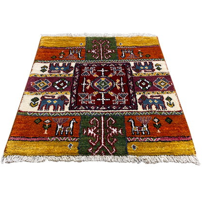 Colorful Gabbeh rug with a colorful border pattern, fringes along the edges